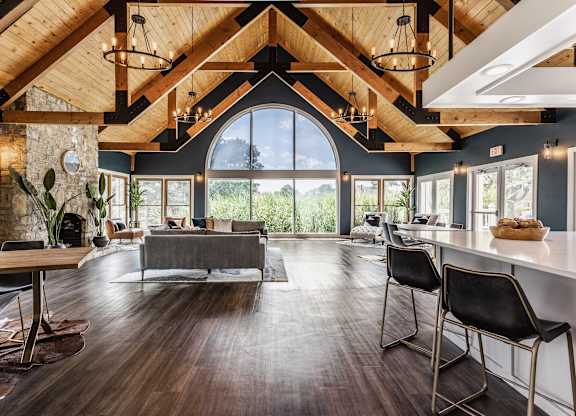 Community clubhouse with seating areas, hardwood-style flooring, and modern decor.