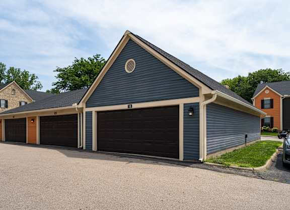 A two-car garage with a circular window above the left door.