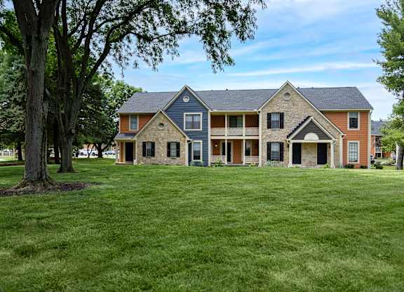A large house with a tree in front of it.