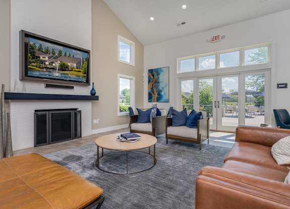 A living room with a fireplace and a painting on the wall.