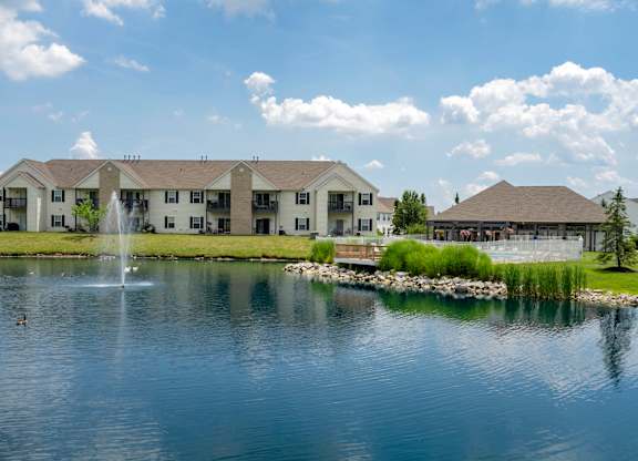 A large building with a fountain in front of it.