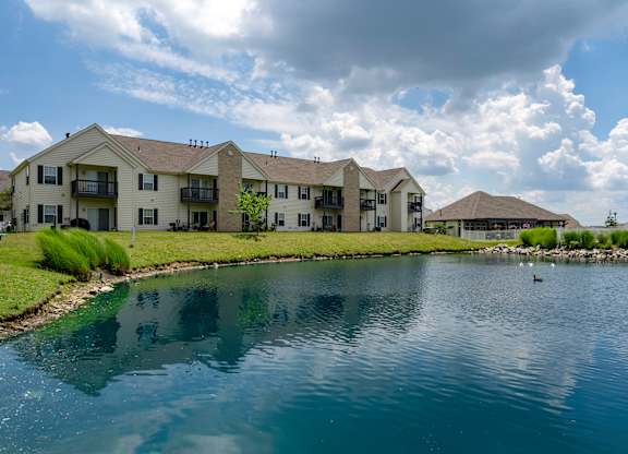 A row of houses with a body of water in front.