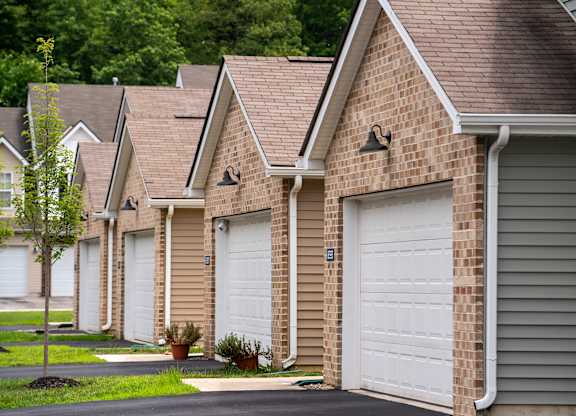 A row of houses with white garage doors.