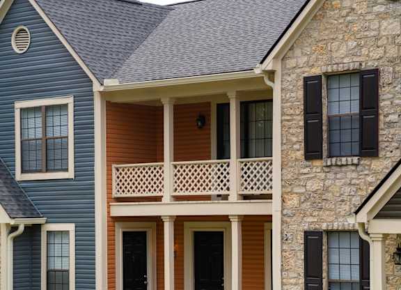A house with a blue siding and a brown door.