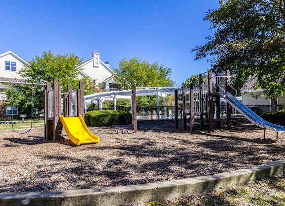 Playground at Britton Woods in Dublin, OH featuring slides, climbing structures, and swings