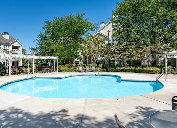 Pool area at Britton Woods Apartments with residential buildings in the background