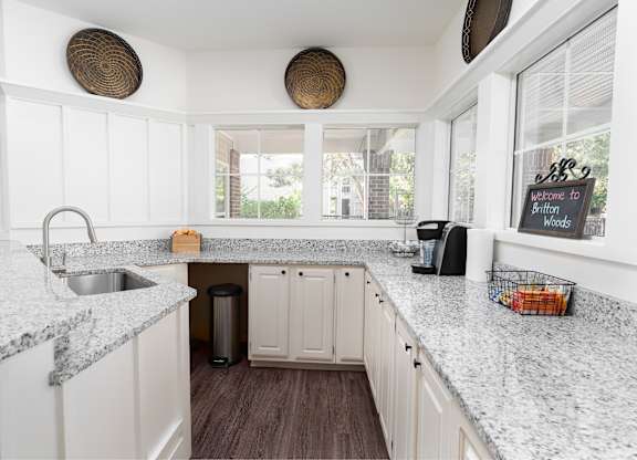 Kitchen with marble countertops and white cabinetry for a clean, modern look