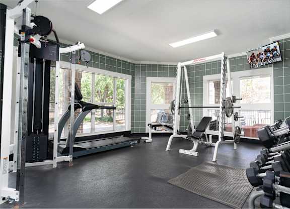 Fitness center at Britton Woods with free weights, cardio equipment, and a large window