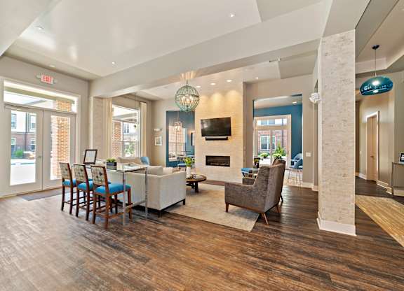 The updated and renovated clubhouse features a game room with a pool table, a full kitchen, and a coffee bar with comfortable seating.