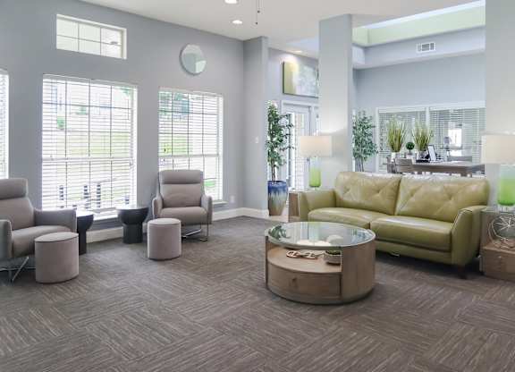 Furnished living room filled with cozy furniture and natural light from a large window