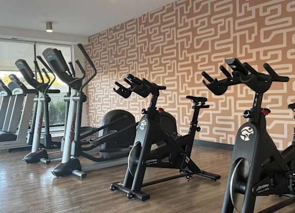 A state-of-the-art fitness center with multiple rooms and a variety of exercise equipment.