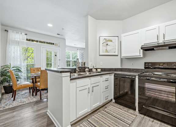 A modern kitchen with white cabinets and a large island.