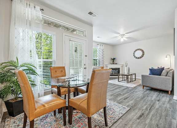 A dining room with a glass table and chairs.