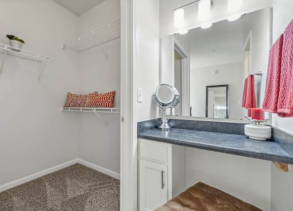 A bathroom with a vanity and a mirror.