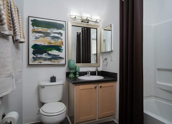 Full bathroom featuring a toilet, sink, and bathtub at The Coleman