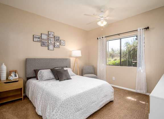 a bedroom with a bed and a window