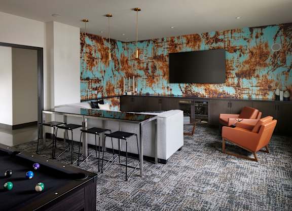 a room with a pool table and a bar
