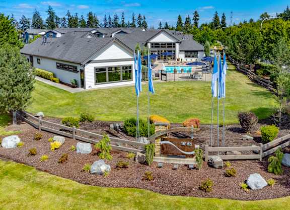 a backyard with blue flags and a house and a yard with a garden