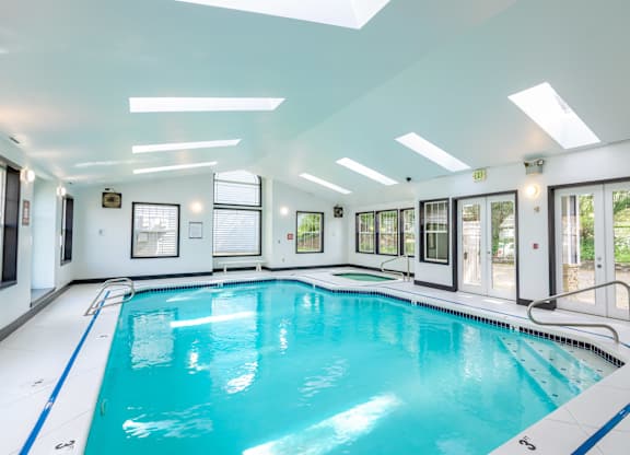 A large indoor swimming pool with a blue line on the side.