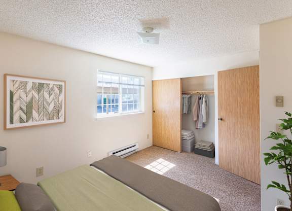 A bedroom with a bed, a lamp, a painting, and a closet.