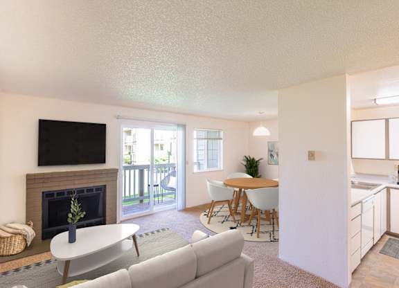 A living room with a grey couch, a white coffee table, and a fireplace.