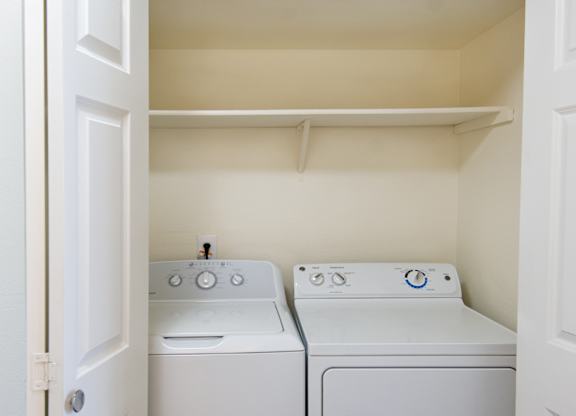 a small laundry room with a washer and dryer