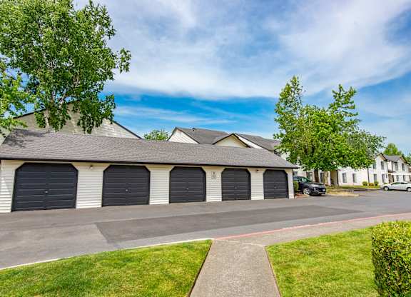 a house with two garages on the side of the road