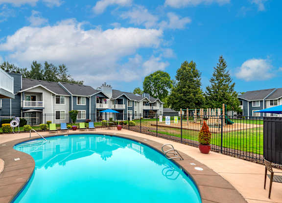 a swimming pool with houses in the background