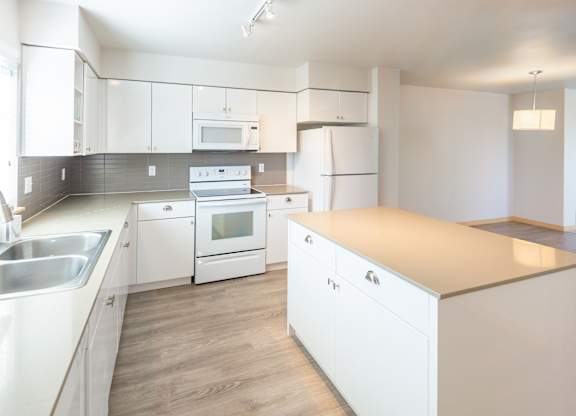 a kitchen with white cabinets and white appliances