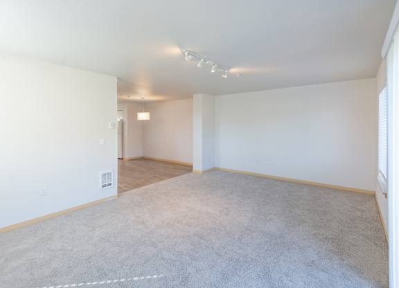 a bedroom with a carpeted floor and white walls