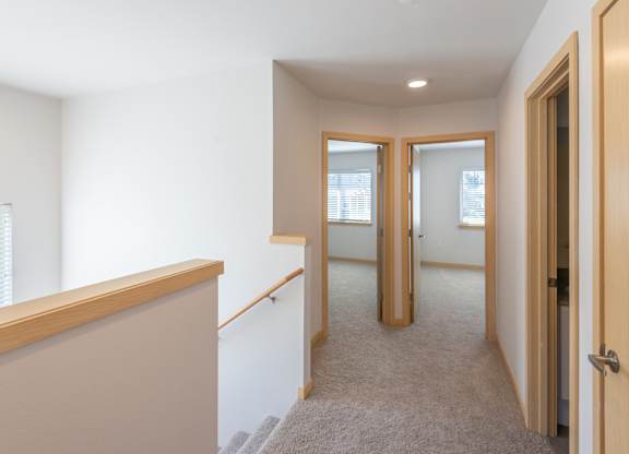 a view of the hallway from the top of the stairs in a 555 waverly unit