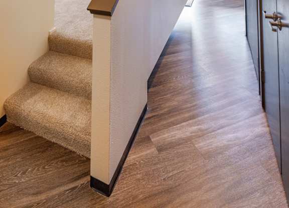 a hallway with stairs and a partition wall in a building
