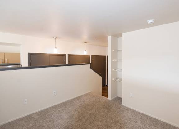 a living room with a carpeted floor and a white wall