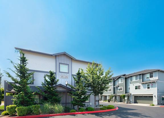 the view of an apartment building with a street in front of it