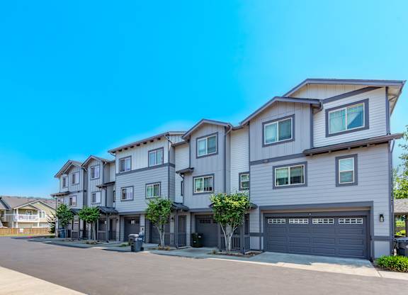 a row of town houses with garage doors