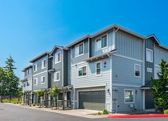 a row of town houses with a street in front of them