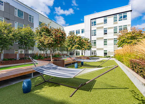 A modern building with a green lawn in front.