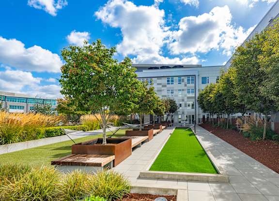 A modern building with a green lawn in front.