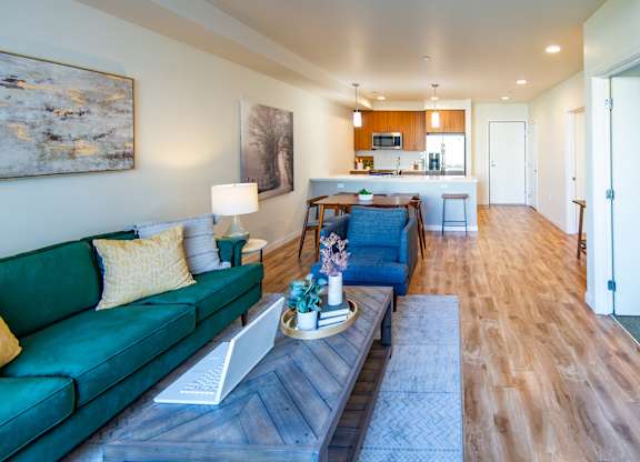 A living room with a green couch and a coffee table.