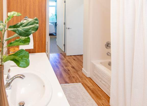 A white sink with a vase on it in a bathroom.