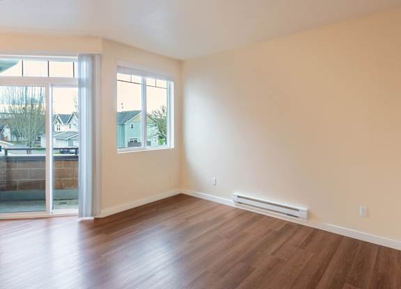A room with a sliding glass door and a window.