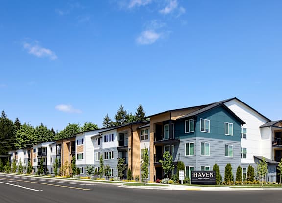 an image of a apartment building with a blue sky in the background