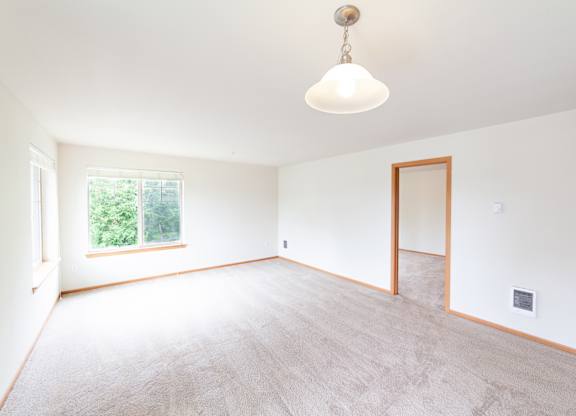 a bedroom with white walls and carpet
