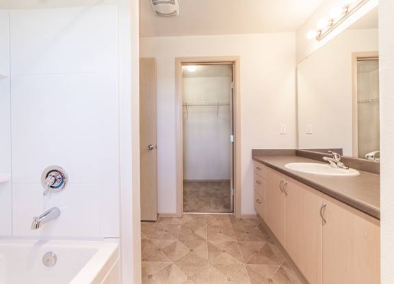 a bathroom with a bathtub and a sink
