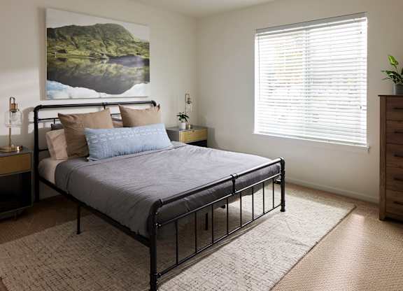 a bedroom with a bed and a dresser