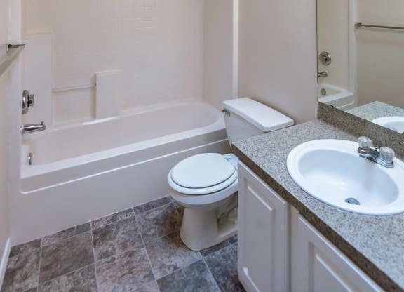 a bathroom with a sink toilet and a bath tub