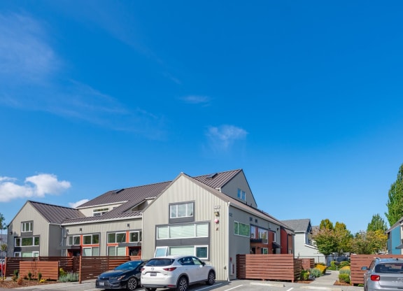the exterior of a house with cars parked in front of it