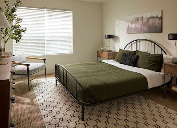 a bedroom with a bed and a chair