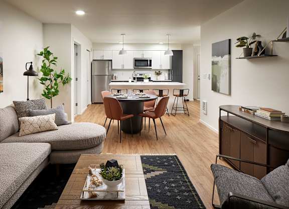 an open concept living room and kitchen with a dining room table and chairs