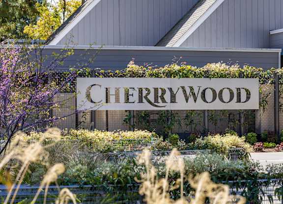 A sign that says Cherrywood in front of a building at Cherrywood Apartments, California, 95118